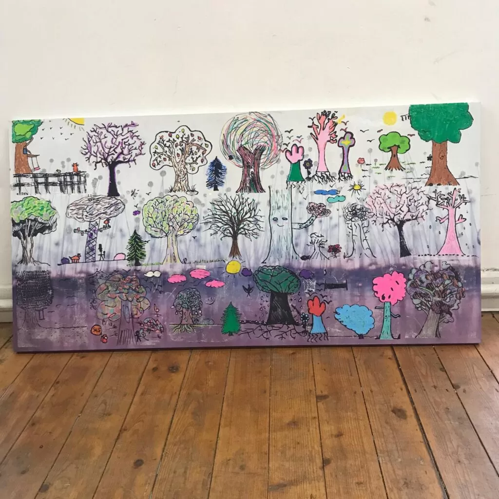 A canvas with trees drawn onto it and coloured in.